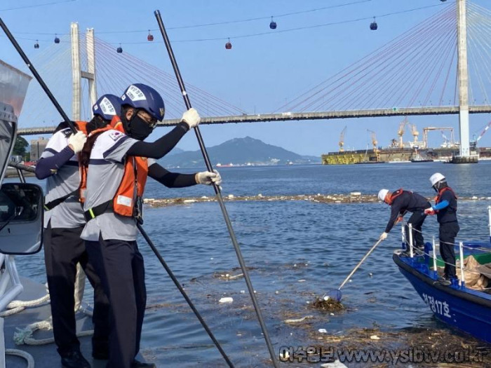 [크기변환]해양경찰과 해양환경관리공단직원들이 호우로 인해 유입된 해양쓰레기를 수거하고 있다..jpg